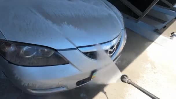 Driver Washes Headlights Hood Car Hose Self Service Car Wash — стоковое видео