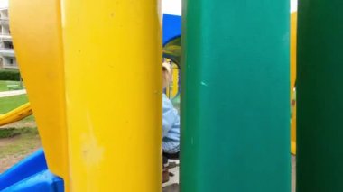 Pofuduk tavşanlı küçük bir kız borudan çıkar ve oyun parkındaki kayaktan aşağı kayar. Yüksek kalite 4k görüntü