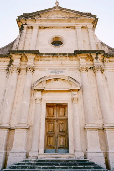 stock image Facade of the Church of the Our Lady Birth with a wooden door. Prcanj, Montenegro. High quality photo