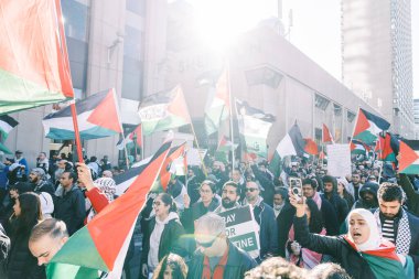 Filistinlilerin Gazze 'deki İsrail saldırısına karşı Toronto' da savaş karşıtı yürüyüş. İsrail-HAMAS savaşını barışçıl bir şekilde protesto ediyor. Protestocular bayrak sallıyor. Filistin soykırımı.