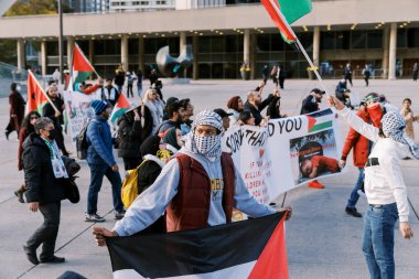 Filistinlilerin Gazze 'deki İsrail saldırısına karşı Toronto' da savaş karşıtı yürüyüş. İsrail-HAMAS savaşını barışçıl bir şekilde protesto ediyor. Protestocular bayrak sallıyor. Filistin soykırımı.