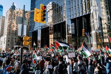 Filistinlilerin Gazze 'deki İsrail saldırısına karşı Toronto' da savaş karşıtı yürüyüş. İsrail-HAMAS savaşını barışçıl bir şekilde protesto ediyor. Protestocular bayrak sallıyor. Filistin soykırımı.