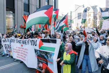 Filistinlilerin Gazze 'deki İsrail saldırısına karşı Toronto' da savaş karşıtı yürüyüş. İsrail-HAMAS savaşını barışçıl bir şekilde protesto ediyor. Protestocular bayrak sallıyor. Filistin soykırımı.