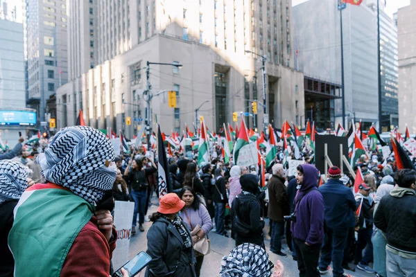 Filistinlilerin Gazze 'deki İsrail saldırısına karşı Toronto' da savaş karşıtı yürüyüş. İsrail-HAMAS savaşını barışçıl bir şekilde protesto ediyor. Protestocular bayrak sallıyor. Filistin soykırımı.