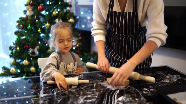 Little Daughter Sits Next Her Mother Rolling Out Dough Table — Stock Video