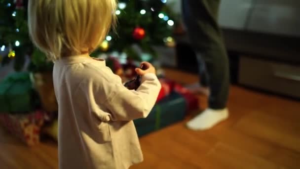 Ein Kleines Mädchen Sieht Wie Ihre Mutter Geschenke Unter Einem — Stockvideo
