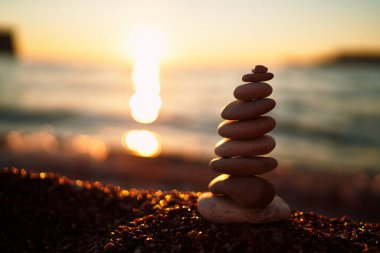 Cairn batan güneşin ışınlarıyla deniz kıyısında uzanır. Yüksek kalite fotoğraf