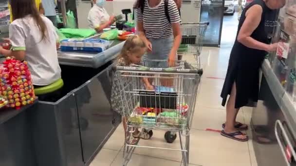 Mama Małą Dziewczynką Sprzedaje Towar Wózka Supermarkecie Wysokiej Jakości Materiał — Wideo stockowe
