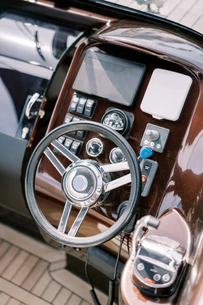 Steering wheel and control panel of a modern motor yacht. Top view. High quality photo