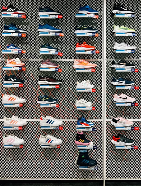 Mağazadaki raflarda çok renkli spor ayakkabılar var. Yüksek kalite fotoğraf