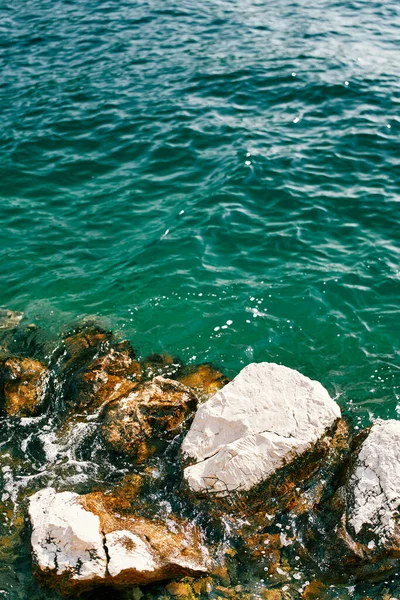 Sea waves roll on coastal rocks. High quality photo