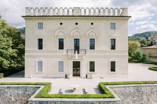 Wedding dress hangs on the balcony above the entrance of Villa Rizzardi. Valpolicella, Italy. High quality photo