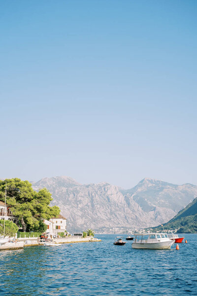 Boats are moored in the sea off the coast of Perast. Montenegro. High quality photo