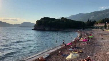 Turistler Villa Milocer yakınlarındaki sahilde güneşleniyor. Karadağ. Yüksek kalite 4k görüntü