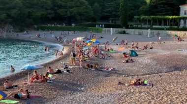 Turistler Villa Milocer yakınlarındaki plajda dinleniyorlar. Karadağ. Yüksek kalite 4k görüntü