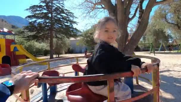 Dad Rolls Little Girl Carousel Playground High Quality Footage — Stock Video