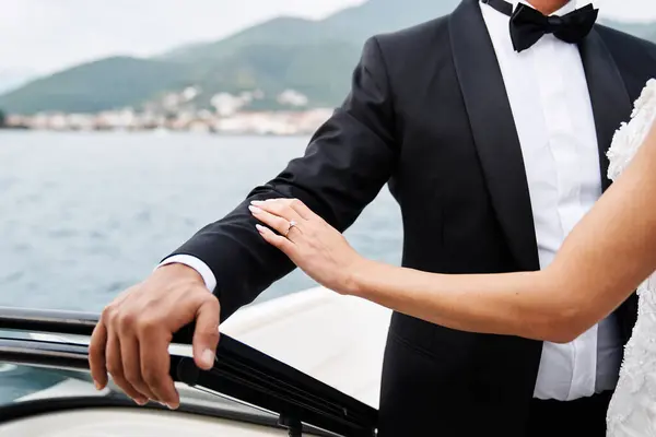 Bride Touches Groom Hand While Standing Boat Floating Sea Cropped Stock Image