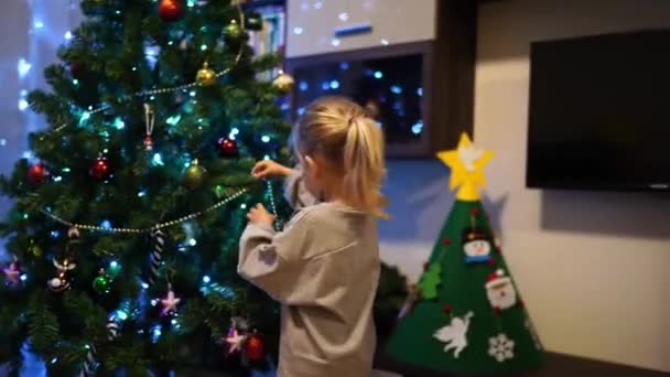 Little Girl Decorates Christmas Tree Garland Beads High Quality Footage Video Clip
