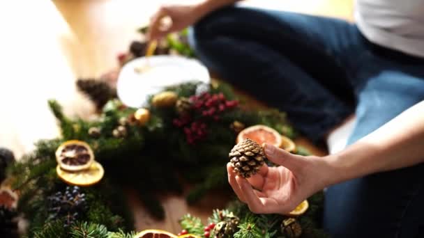 Woman Applying Gold Paint Fir Cone Christmas Wreath High Quality Stock Video