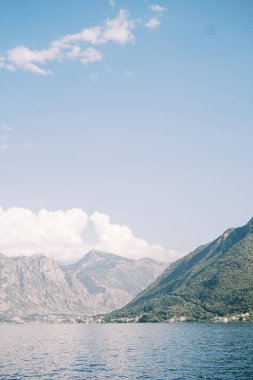 Denizden, güneşin altındaki dağlık sahile bak. Yüksek kalite fotoğraf