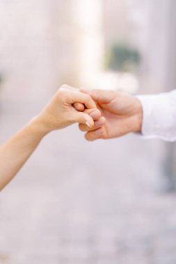 Damat gelinin elini kendi tutuyor. Kırpılmış. Yüzsüz. Yüksek kalite fotoğraf