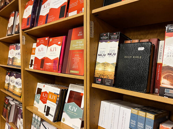 Bibles and religious books stand on the shelves. High quality photo