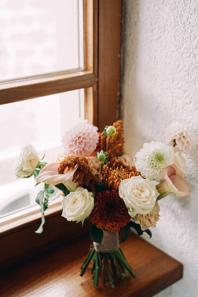 Bride bouquet stands on the windowsill in the room. High quality photo — Stock Image Bride Bouquet Stands Windowsill Room High Quality Photo Stock Picture