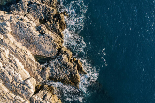 Sea waves roll onto the steep rocky shore. Drone. High quality photo — Stock Image Sea Waves Roll Steep Rocky Shore Drone High Quality Photo Stock Photo
