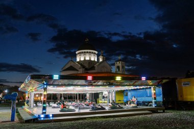 Colorful funfair with bumper cars in the park. High quality photo clipart