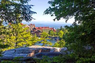 View of historic Mohonk Mountain House, a luxury resort in the Shawangunk Mountains in New Paltz, New York clipart