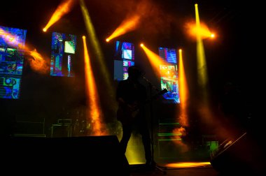 Rock concert male singer silhouette with stage lights 