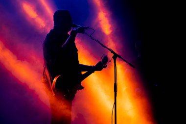 Silhouette of a singer guitarist performing at a rock concert