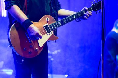 Guitar of a singer and guitarist of a band performing at a rock concert.