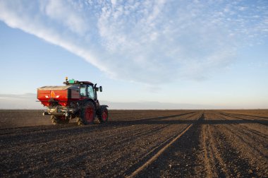 Traktör yapay gübre yayıyor. Ulaşım, tarım.