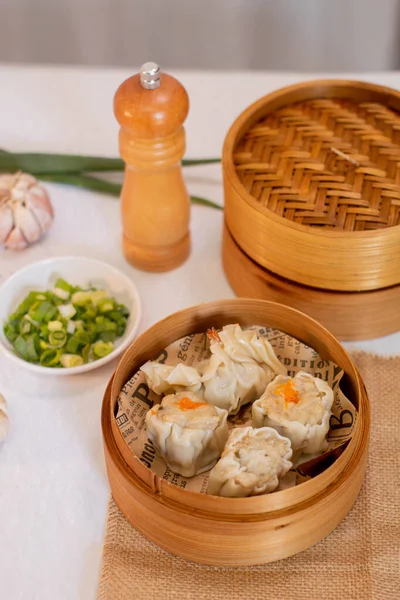 Tangerang Selatan, Indonesia - Feb 5, 2023: steamed dumpling dimsum in traditional bamboo steamer