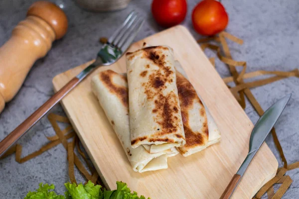 Kebabs are foods made from chunks of meat and vegetables covered with tortilla skin, eaten with mayonnaise and chili sauce,soft focus. defocused food photography