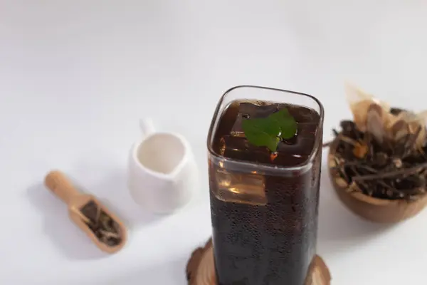 glass of ice ayurvedic herbal black tea or Liang tea. The Time of Tea Break. Liang teh Medan. drink of herbal tea Liang