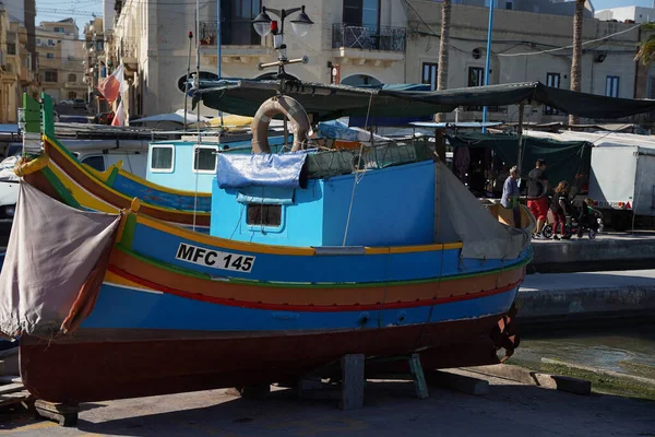 malta colorful painted fishing boat in marsaxlokk harbor