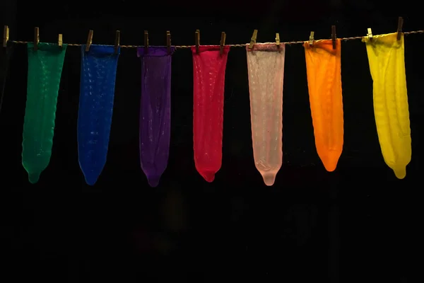 Many Contraceptives Condoms Hanging Rope Isolated Black Background — Stock Photo, Image