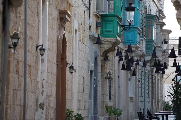 painted bow windows Malta Rabat medieval village building street