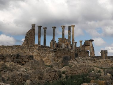 Volubilis Roman ruins in Morocco- Best-preserved Roman ruins located between the Imperial Cities of Fez and Meknes on a fertile plain surrounded by wheat fields.