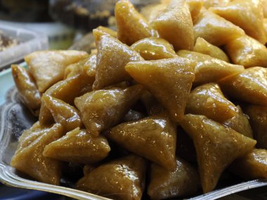 Moroccan biscuits and pastries dipped in honey for sale in the Medina of Fez in Morocco
