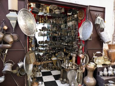 Copper ware shop with crockery, pots and pans in the metal work part of Fes soukh, Morocco