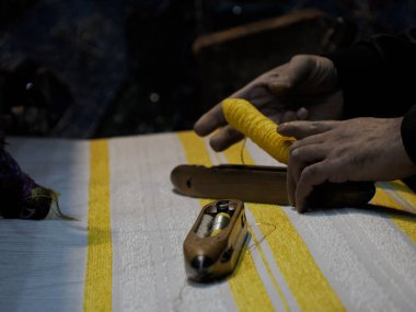 Close up of the threads in a wooden loom in a textile store in Fez, Morocco