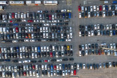 Aerial view over huge outdoor parking lots with many cars and vehicles in Genoa, Italy