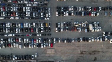 Aerial view over huge outdoor parking lots with many cars and vehicles