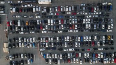 Aerial view over huge outdoor parking lots with many cars and vehicles
