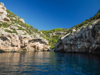 Hırvatistan adası turkuvaz su ve kaya uçurumları, berrak bir yaz gününde şeffaf berrak deniz suyu