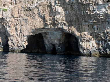 Hırvatistan adası turkuvaz su ve kaya uçurumları, berrak bir yaz gününde şeffaf berrak deniz suyu