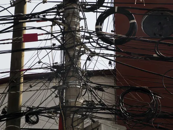 Mexico City, Messed up power lines and connection cables. Many tangled wires on electric poles in the city